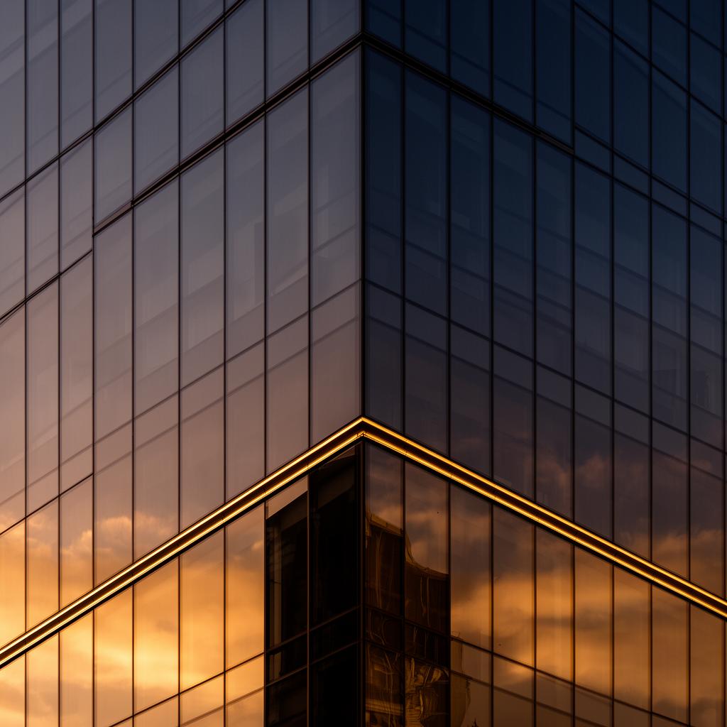 Architectural detail of a glass tower at sunset